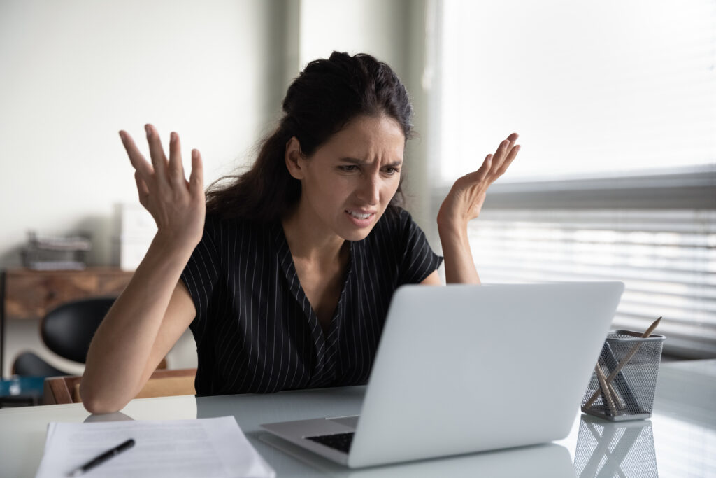 Mad young woman worker losing job result on broken pc